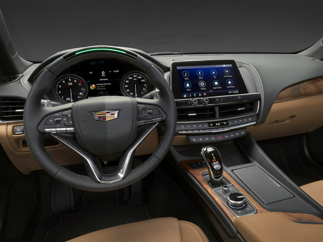 The steering wheel and front seats of a Cadillac